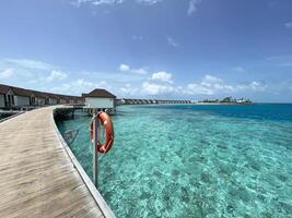 The bridge along the ocean at Maldives photo