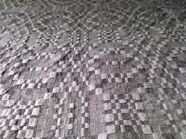 Handmade homespun fabric in an old rustic ethnic style. Traditional warm handmade texture effect. photo