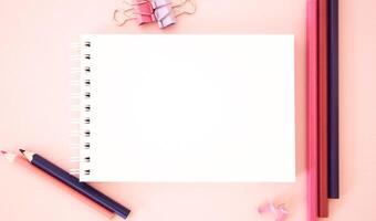 Template. Pink background with pencils.The image shows Free Space For Text on a notebook on pink background. Bright picture. Concept Image photo