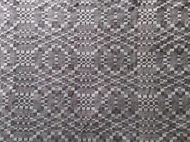 Handmade homespun fabric in an old rustic ethnic style. Traditional warm handmade texture effect. photo