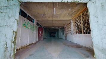Corridor of abandoned building. Action. Old crumbling building with corridor and flashing lamp. Abandoned building with lobby video