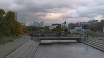 Top view of river with parks in center of modern city. Stock footage. Beautiful panorama of city with river on cloudy summer day. River in center of modern city with bridges and green parks video