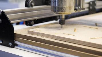 Close-up of carpenter's machine cutting wooden boards. Media. Beautiful patterns on wood with automated machine. Wood carving by automated machine video