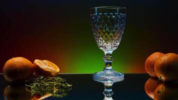 Close up of pouring orange soda into the glass. Stock clop. Soft drink with the taste of citrus and orange fruits on the reflective table surface. video