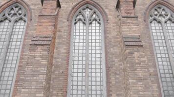 Ancient walls of historic building with high windows. Action. High antique windows in European style. Exterior of exterior walls of architectural old building video