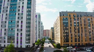 A bird's-eye view of the landscape. Stock footage.A city built up with tall houses with a highway outside the window where cars drive and courtyards where residents walk. video
