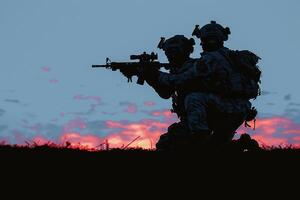 two soldier wearing camouflage are one is holding the gun, photo