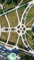 Top aerial view of a city park with a round shaped pond. Creative. Summer park with small paths and green trees. video