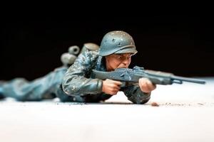 toy soldier with gun in hand lying down, photo