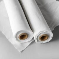 three rolls of tissue roll sitting back to back, photo