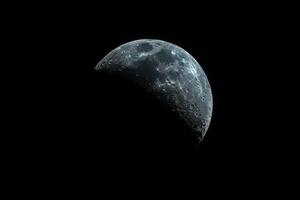 the moon is visible through the dark black sky, photo