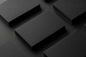 several black business cards stacked over looking at the camera, photo