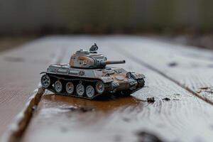 an old toy tank sitting on a wooden table, photo