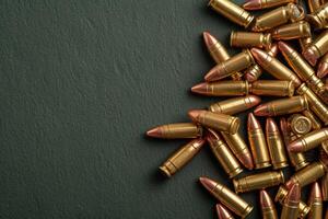 a pile of brass bullet casings near green background, photo
