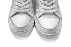 view of white sneakers with leather upper laces, photo