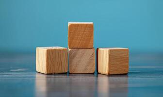 four building blocks lined up on a table, photo