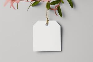 an blank tag tied up to some pink flowers, photo