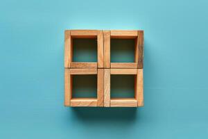 four wooden cubes arranged in a square arrangement on a blue background, photo