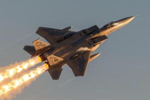 an air force jet flying through a blue sky, photo