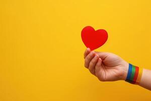 a hand holds up a heart for someone, photo