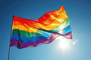 the rainbow flag is blowing in the wind underneath the sun, photo