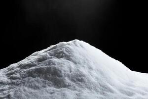 snow is piled on the side of a mountain in front of sunlight, photo
