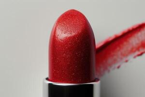 lipstick with red shimmering applied to its lip, photo