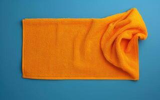 an orange towel and some other material on blue background, photo