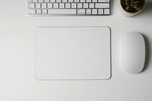 apple mouse with white blank note pad beside, photo
