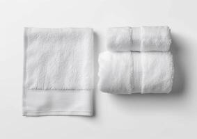 several white folded towels on top of a white surface, photo