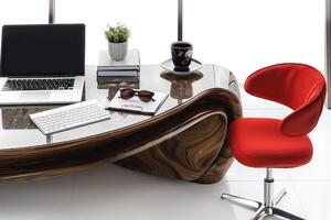 a desk with a laptop and chair in front of it, photo