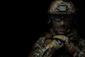 a man wearing camouflage clothes and holding an object, photo