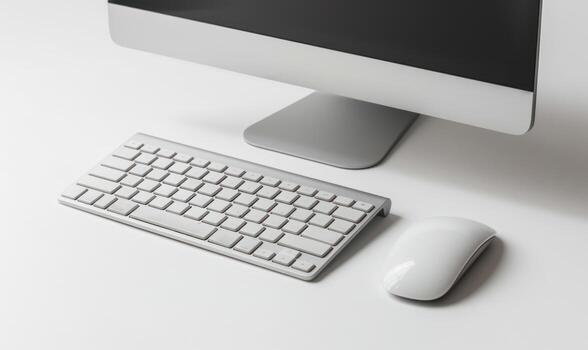 computer monitor and keyboard with laptop in background, photo