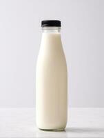 there is a glass bottle with lot of milk inside it, photo