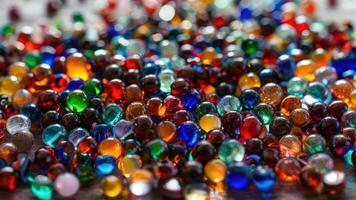 many colorful beads are lined up on a table, photo