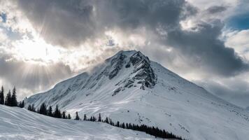a snowy mountain is seen with heavy clouds, photo