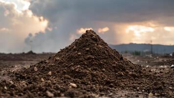 a pile of dirt containing a dirt tractor and two other tractors, photo
