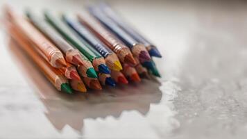 a group of crayon colored pencils are lined up, photo