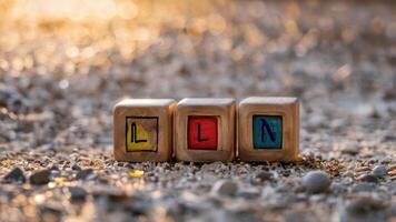 wooden blocks spelling seven seven sitting in sand, photo