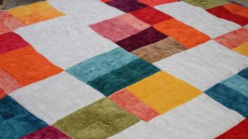 a multi colored patchwork quilt made out of cotton, photo