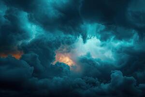 some dark clouds with orange light on them, photo