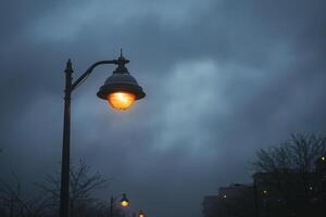 a street light with the city building in the background, photo