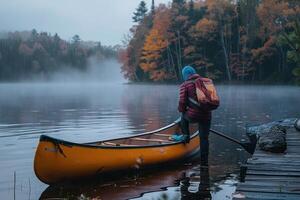 there is a person standing in front of the shore with a yellow canoe, photo