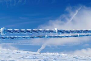 smoke trailing behind two ropes of a snow covered slope, photo