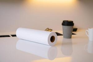 an empty paper rolls on a desk with two coffee cups, photo