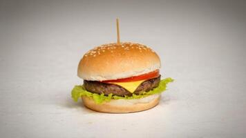 a big hamburger has been topped with cheese, photo