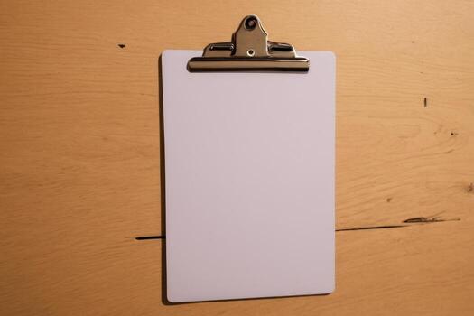 a clip board with one blank paper attached to it, photo