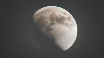 the moon shines brightly in the haze filled blue sky taken at dawn, photo