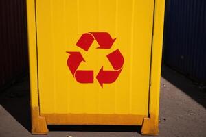 an outdoor trash can with the logo of recycle, photo