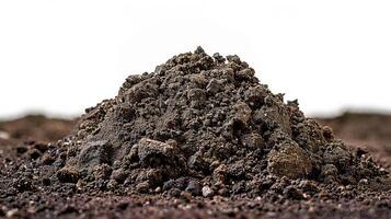 a pile of dirt sitting on top of some brown dirt, photo